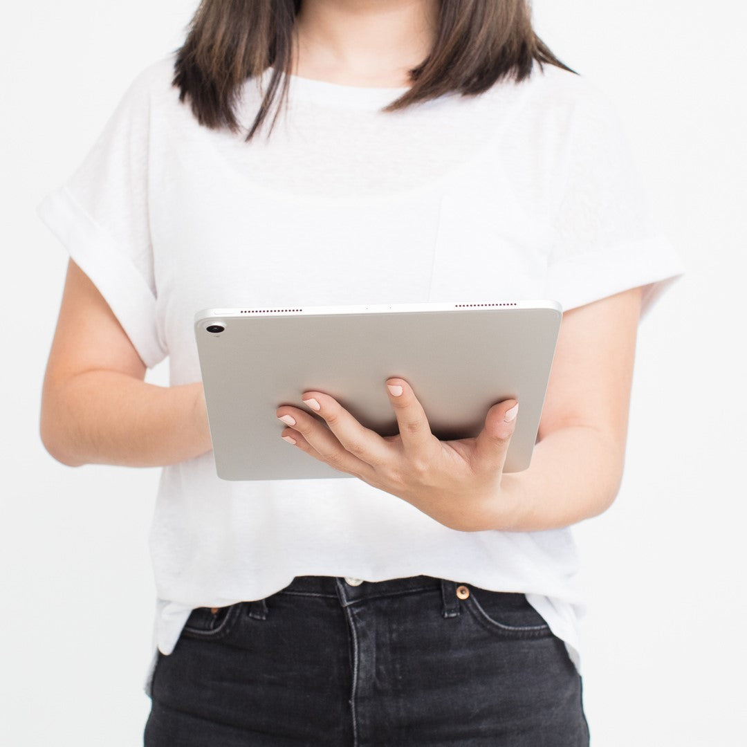 Woman standing and holding a tablet